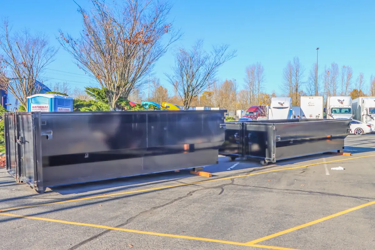 Professional dumpster rental service with roll-off container on residential driveway in Murrysville